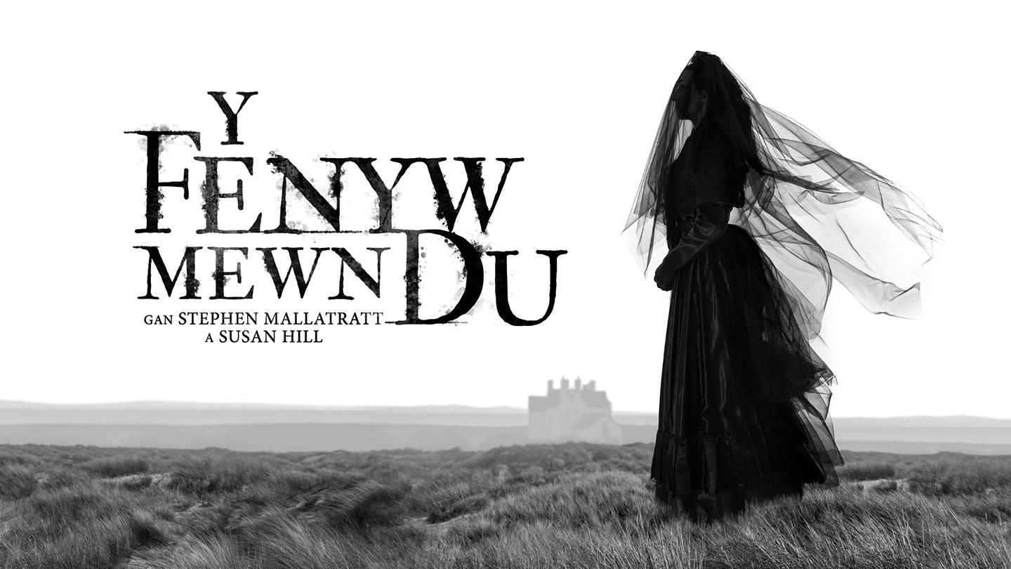 Black and white image of marshland with a house in the background, a woman in a black dress and veil to front and the title 'Y Fenyw Mewn Du'