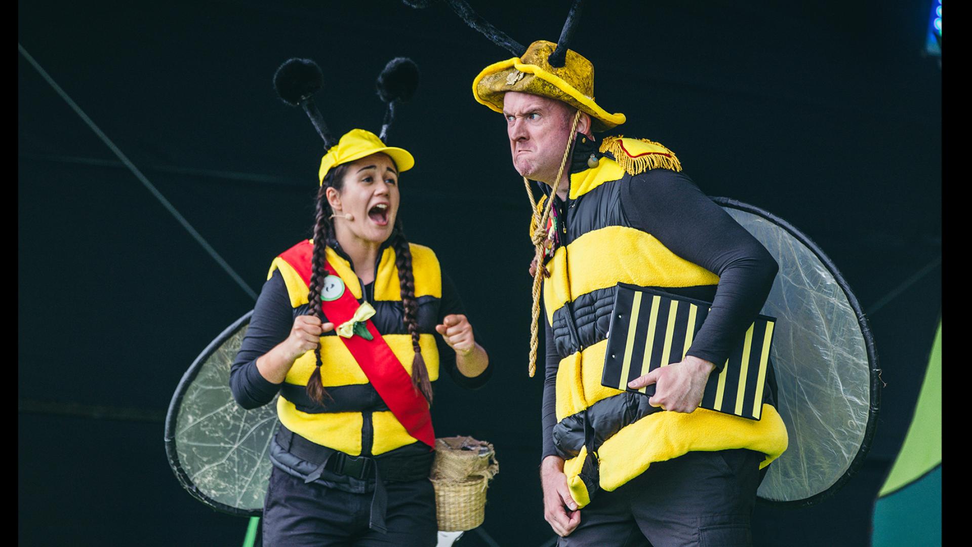 Two people dressed as bees