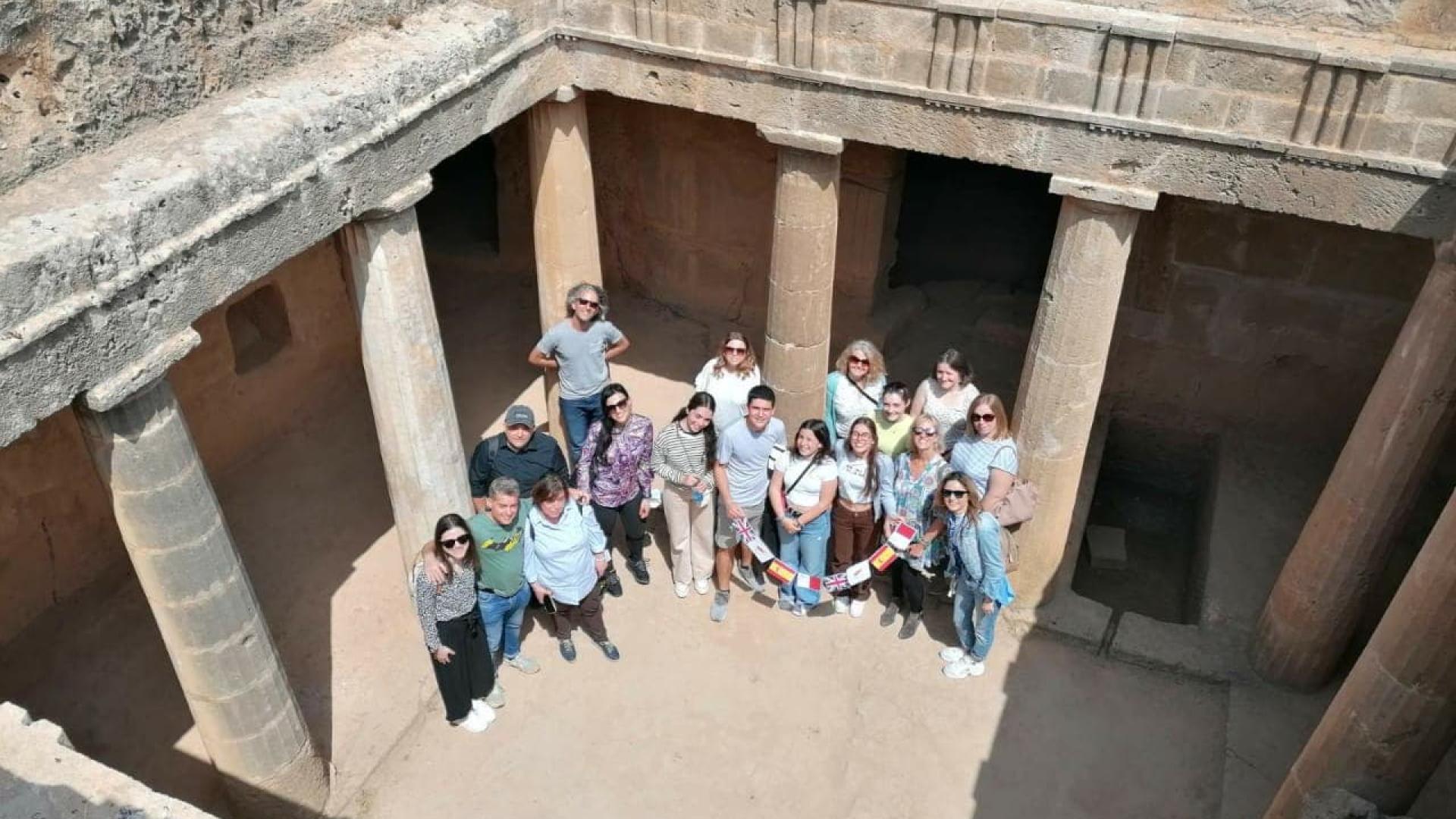 A group of people stood in an archeological tomb
