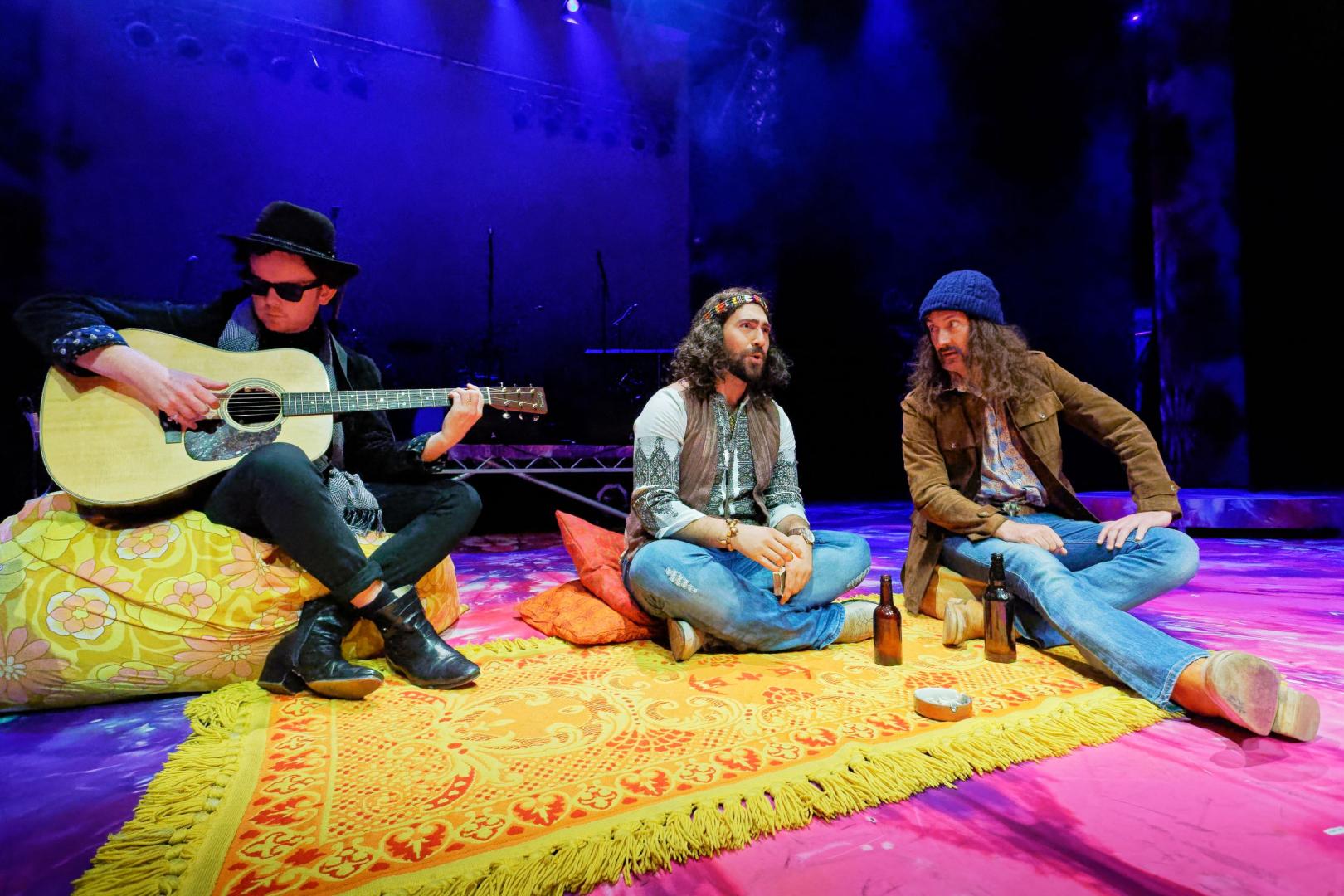 hippies sat on yellow rug chatting