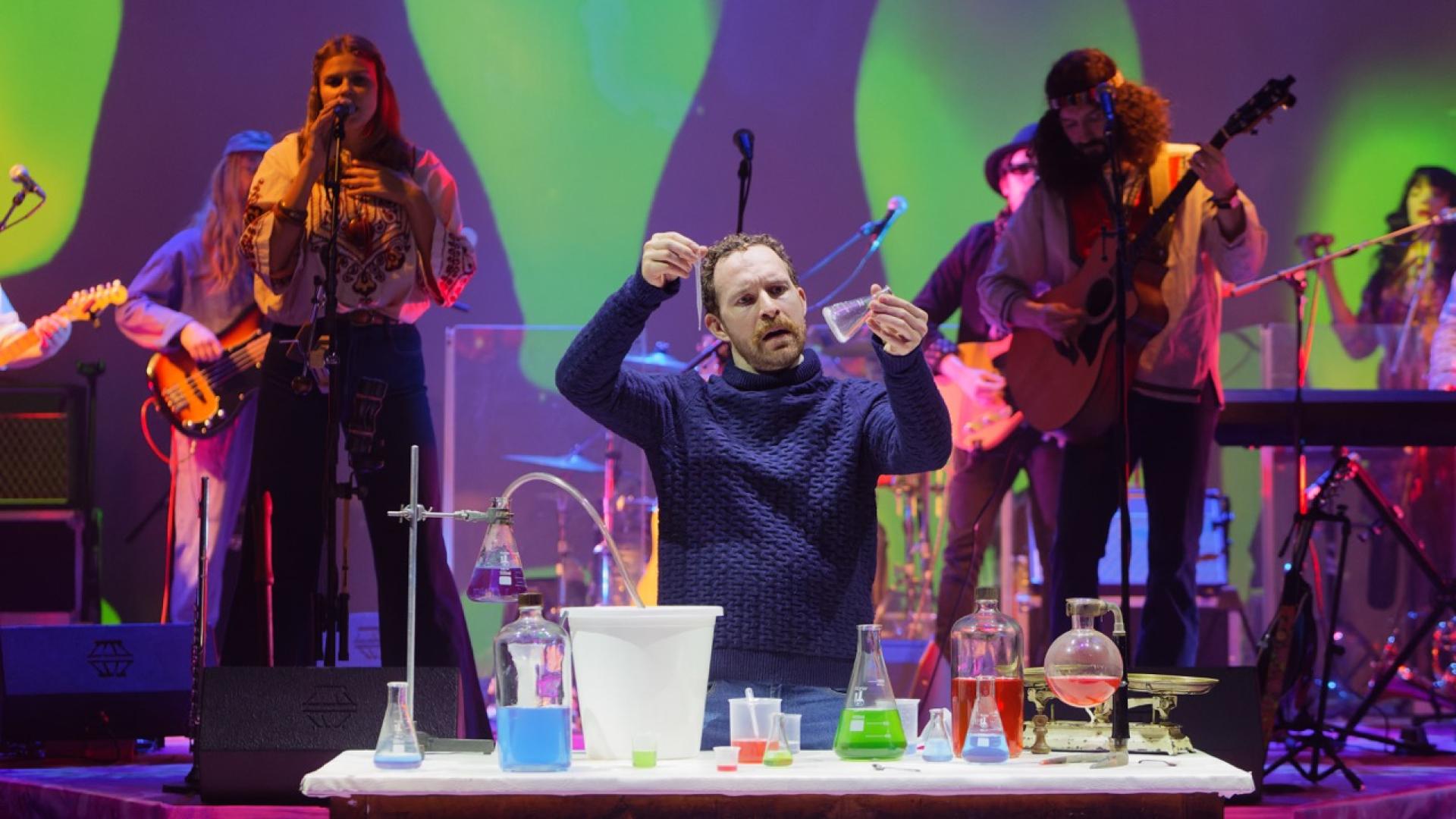 Actor Joseph Tweedale with a table of chemistry equipment