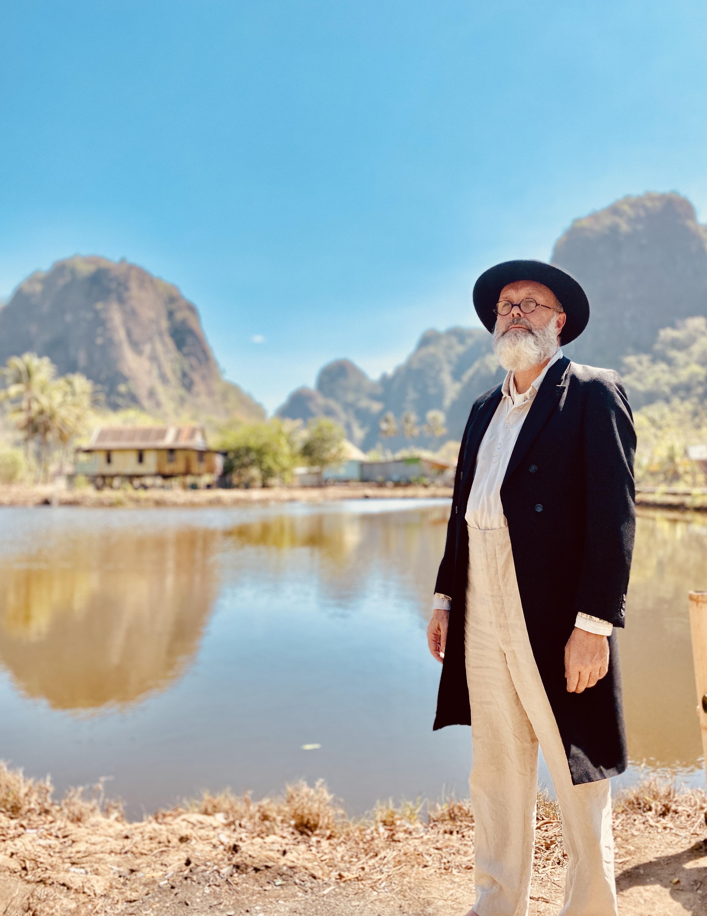 Actor Ioan Hefin dressed as Wallace by a lake in Indonesia